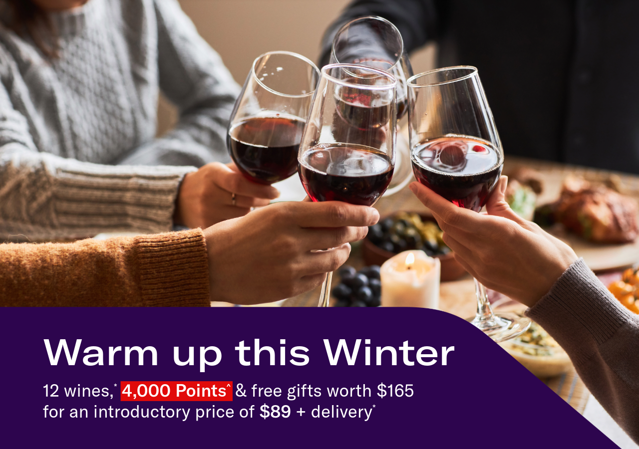 Hands toasting with glasses of red wine. Headline: Warm up this Winter. 12 wines,* 4,000 Points^ & free gifts worth $165 for an introductory price of $89 + delivery*
