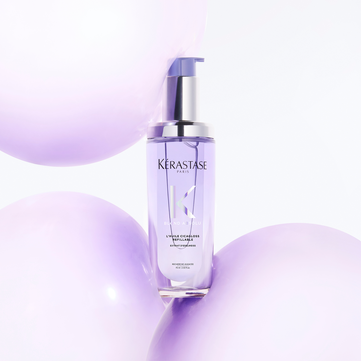 Flacone di olio ricaricabile Kérastase Blond Absolu L'Huile Cica-Gloss tra sfere lilla luminose