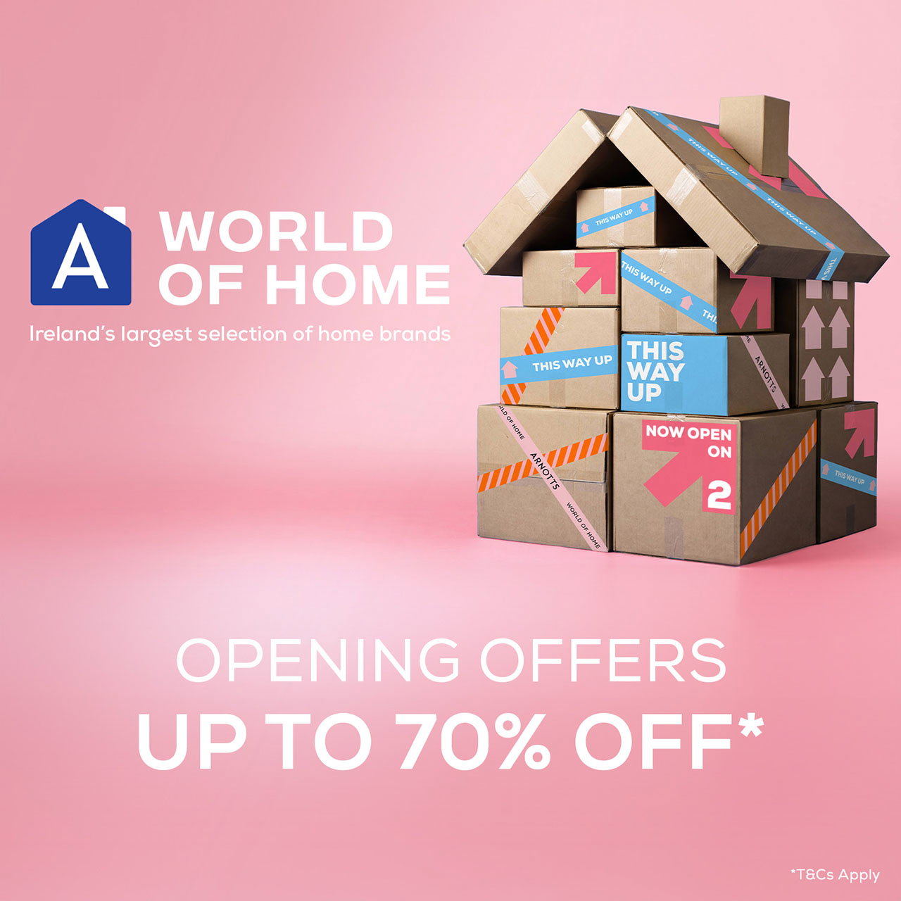 Cardboard boxes stacked to form a house on a pink background, promoting a sale with up to 70% off on home brands in Ireland.
