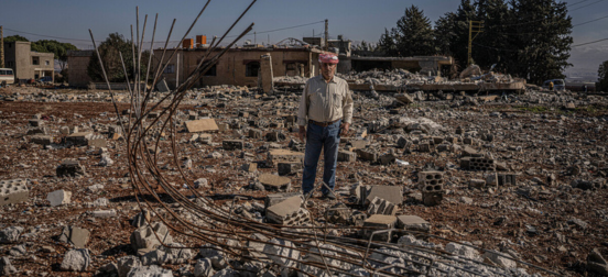 Hussein in the ruin of his home in Lebanon.png
