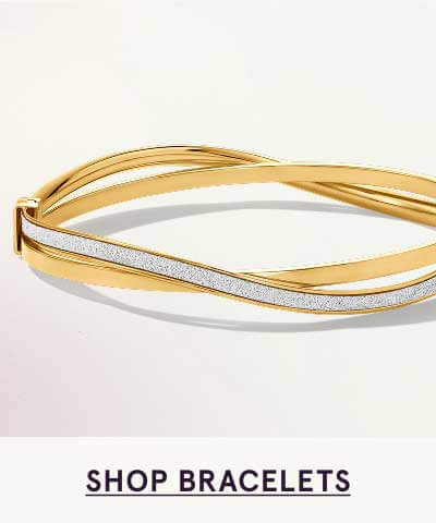 Modern gold crossover design bangle featuring diamond finish on central strand. Click here to shop bracelets