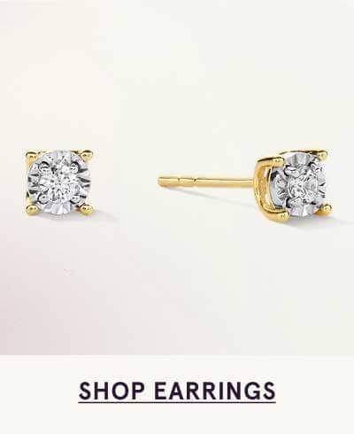 Gold studs showcasing round diamonds set within four-prong basket setting. Click here to shop earrings