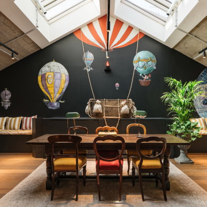 A table sits against the backdrop of a hot air balloon mural