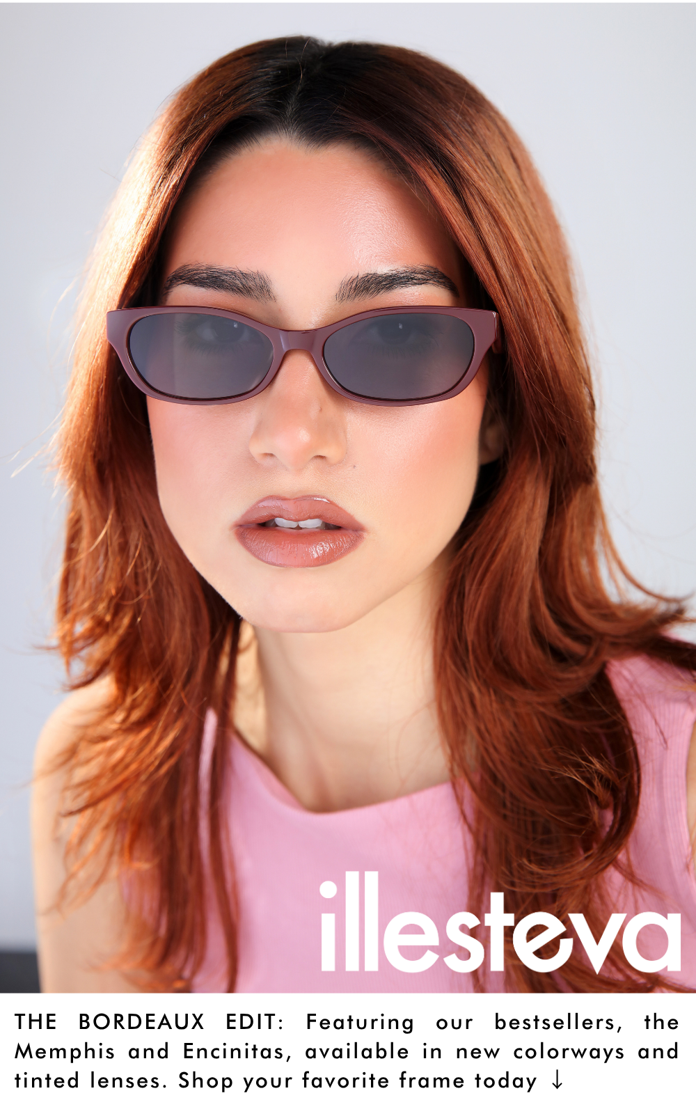A close-up promotional headshot of a woman with auburn hair wearing the Encinitas sunglasses in a glossy bordeaux colorway with dark lenses. The white illesteva logo is superimposed on the lower right corner. Text at the bottom reads: 