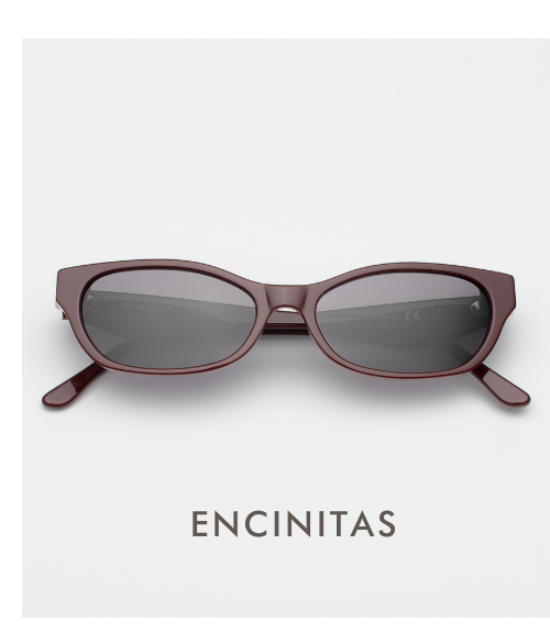 A clean, centered studio product shot of the Encinitas sunglasses. The narrow, rectangular frames are a polished bordeaux with dark grey lenses. The word 