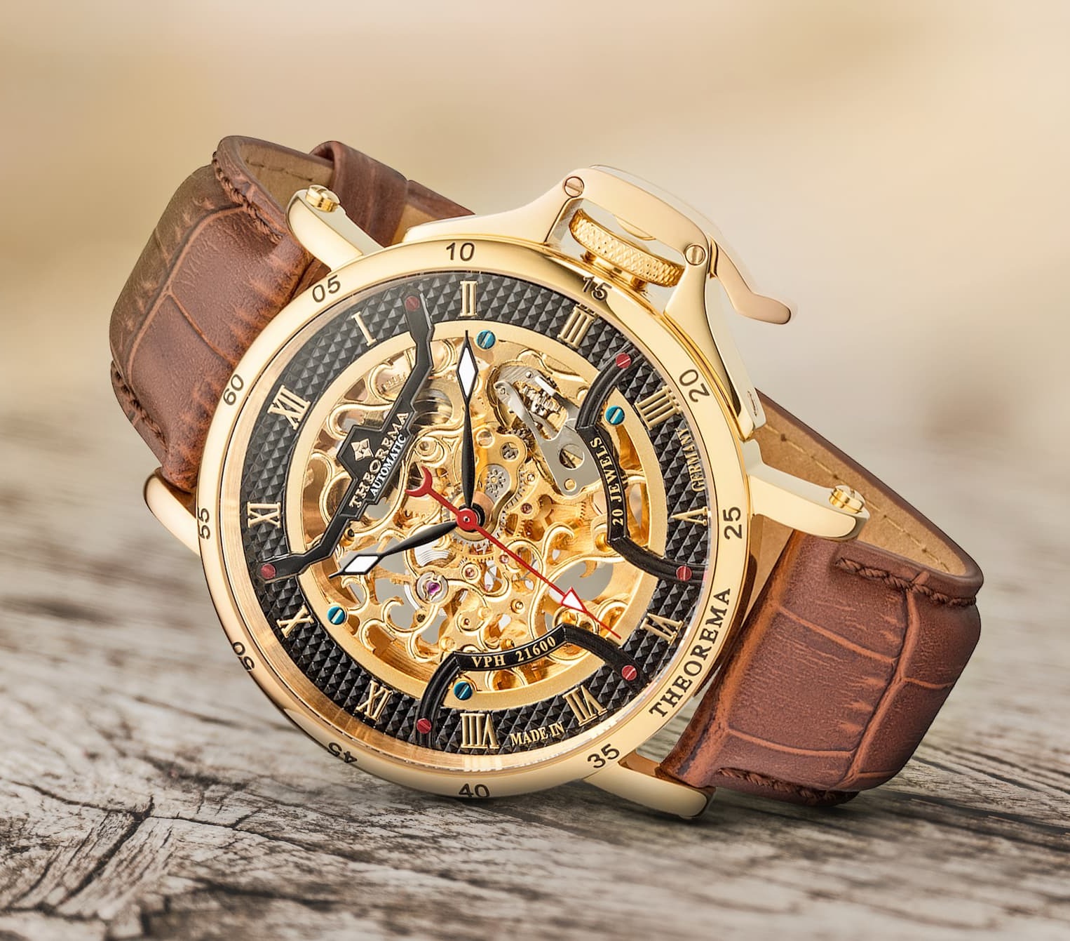 Gold case with gold dial and brown leather band.