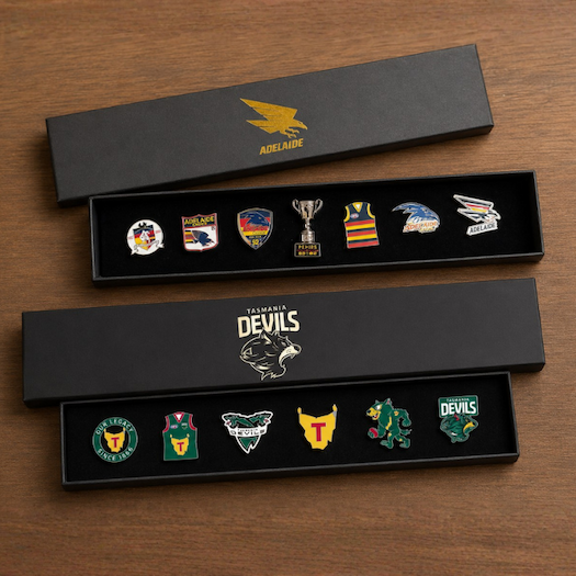 Two AFL Pin Set Gift Boxes sitting on a table