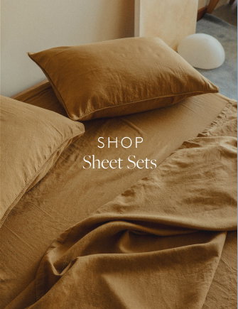 Light brown sheets on a bed