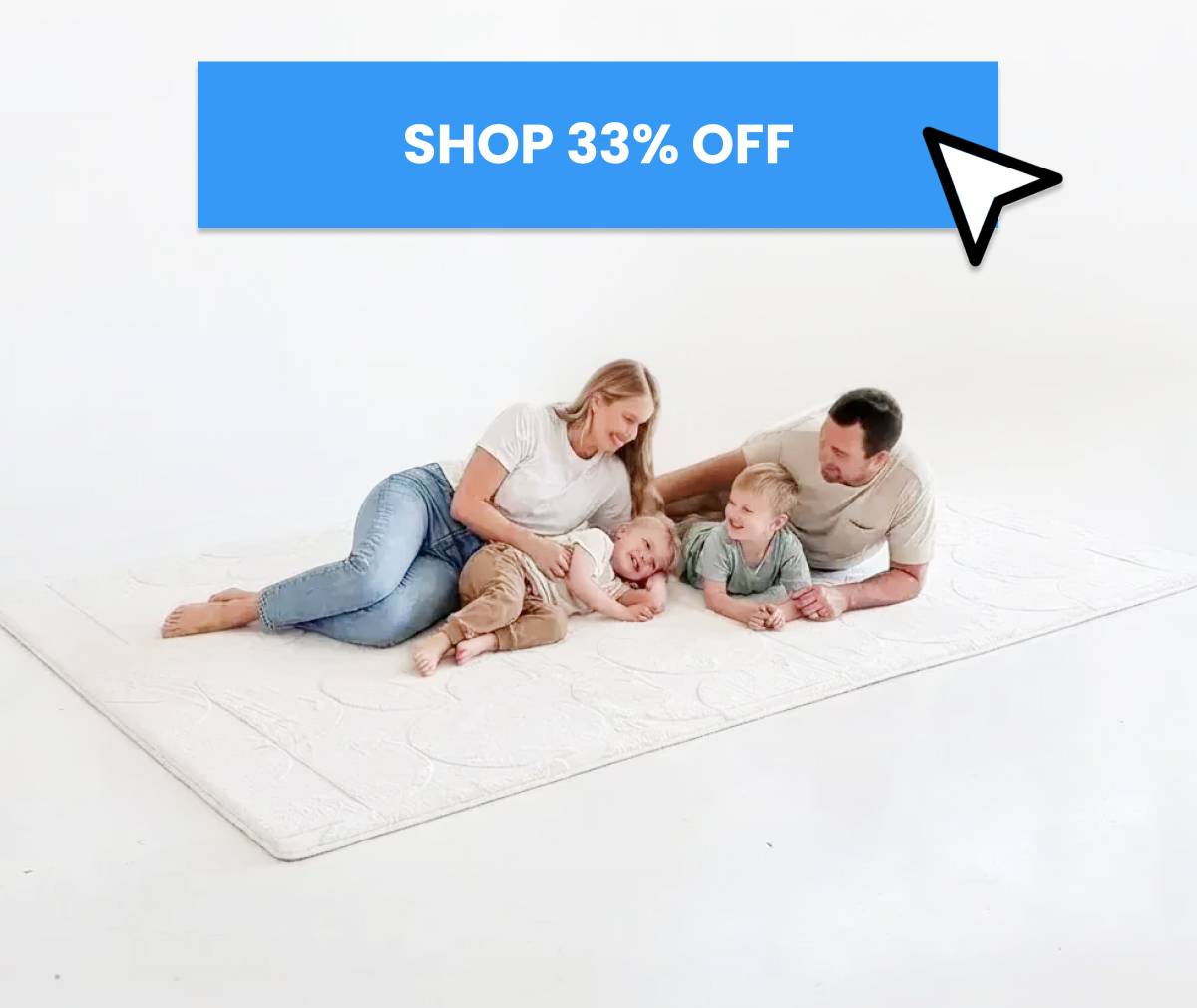A medium shot shows a family of four lying on a white textured rug in a bright, white studio with a blue banner above that reads 'SHOP 33% OFF' and a ...