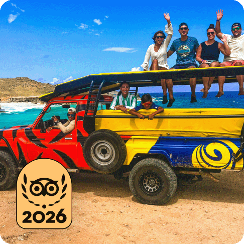 Image Description: A group of people in a colourful bus on the beach. A gold 2026 Travellers’ Choice Best of the Best badge is on the image.
