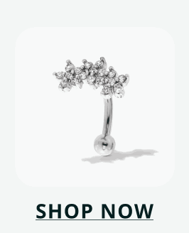 Silver curved barbell topped with an ornate, arching cluster of stones. Click here to shop now