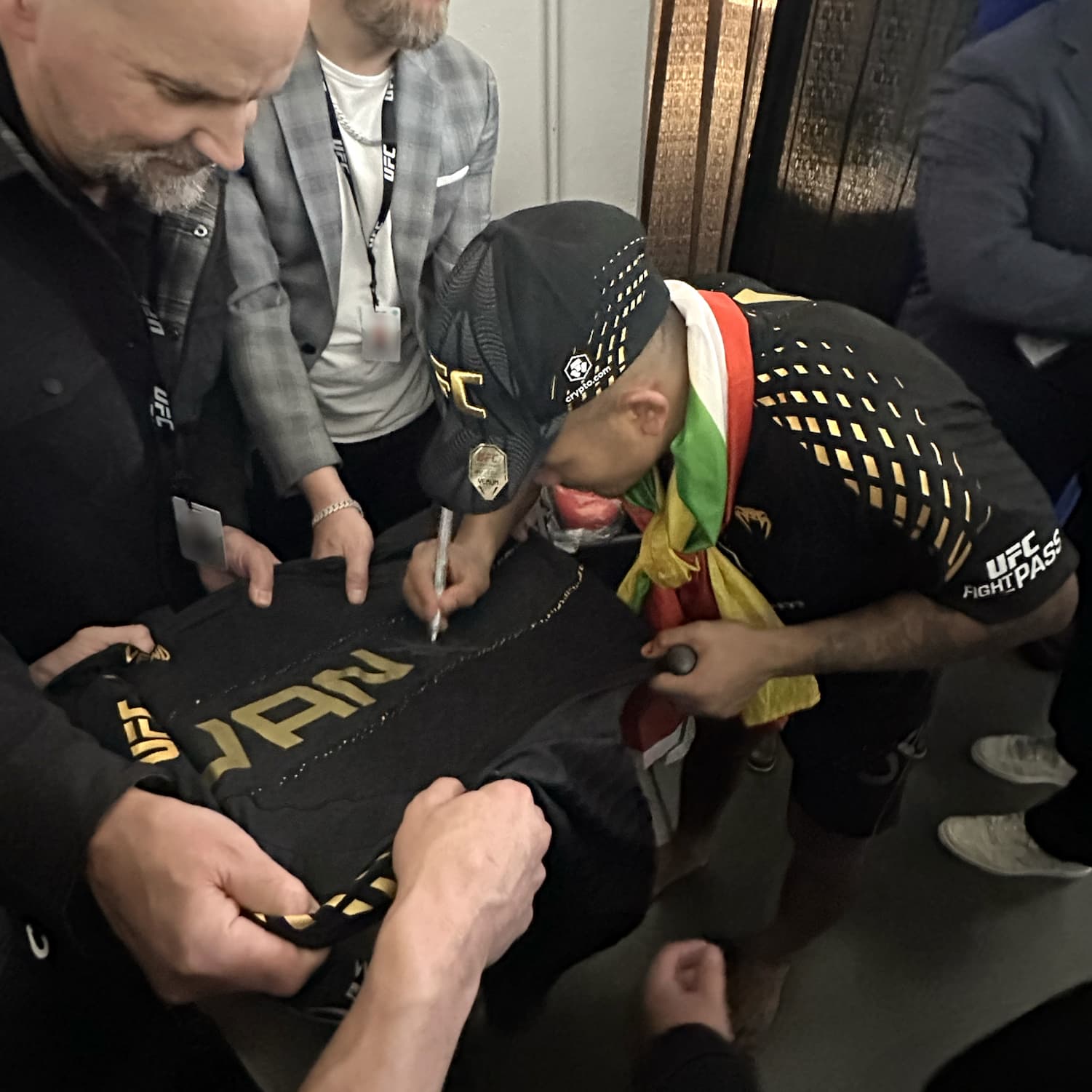 Joshua Signing His Fight Worn Hoodie