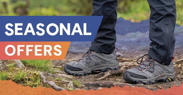 SEASONAL OFFERS. A man walks on a forest path wearing Merrell Men's Moab 3 GORE-TEX Walking Shoes in Beluga.