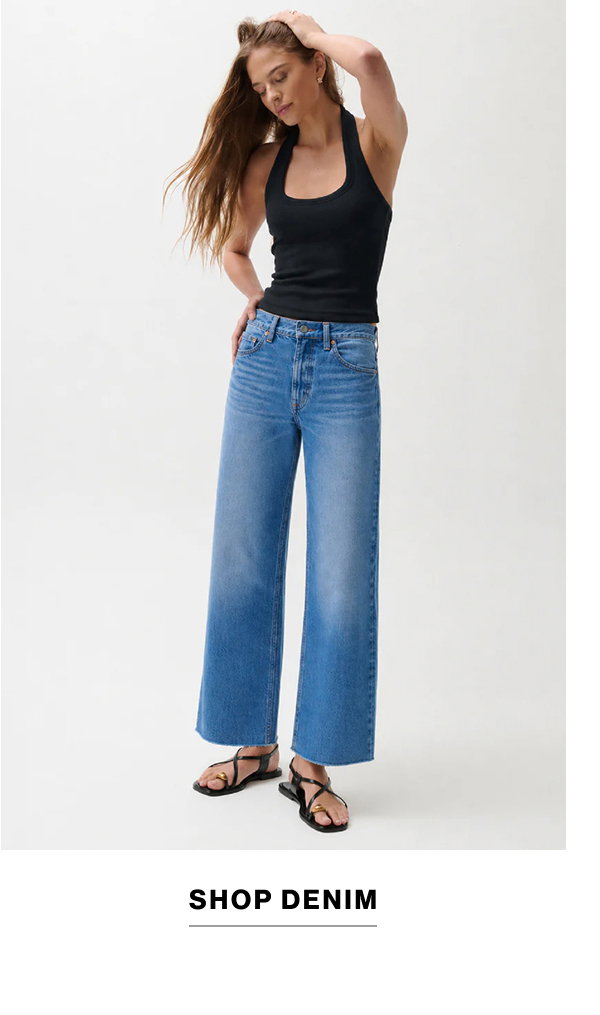 an image of a woman in jeans and a green shirt