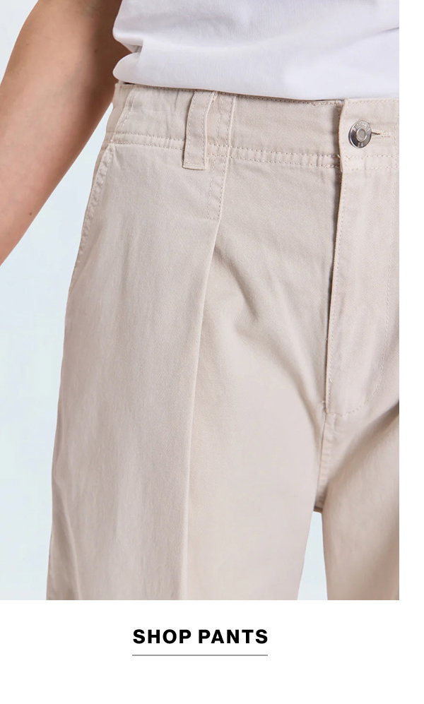 an image of a woman in jeans and a green shirt