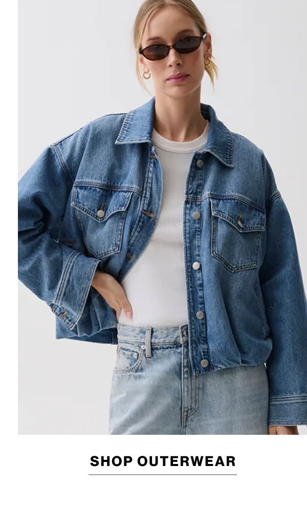 an image of a woman in jeans and a green shirt