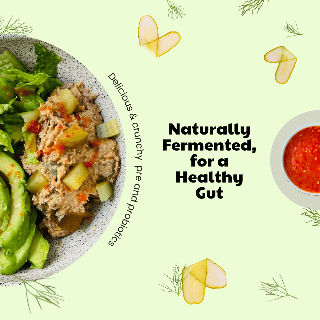 A bowl of healthy salad with tuna or chickpea salad, avocado, and pickles, next to a bowl of red sauce, on a light green background with text about fermentation