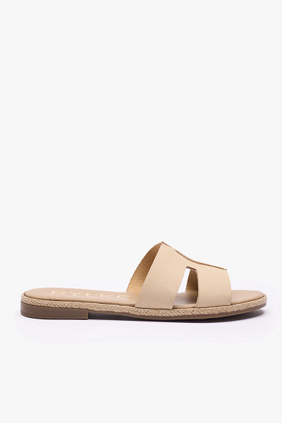 Beige slip-on sandal with cut-out design and flat sole on white background