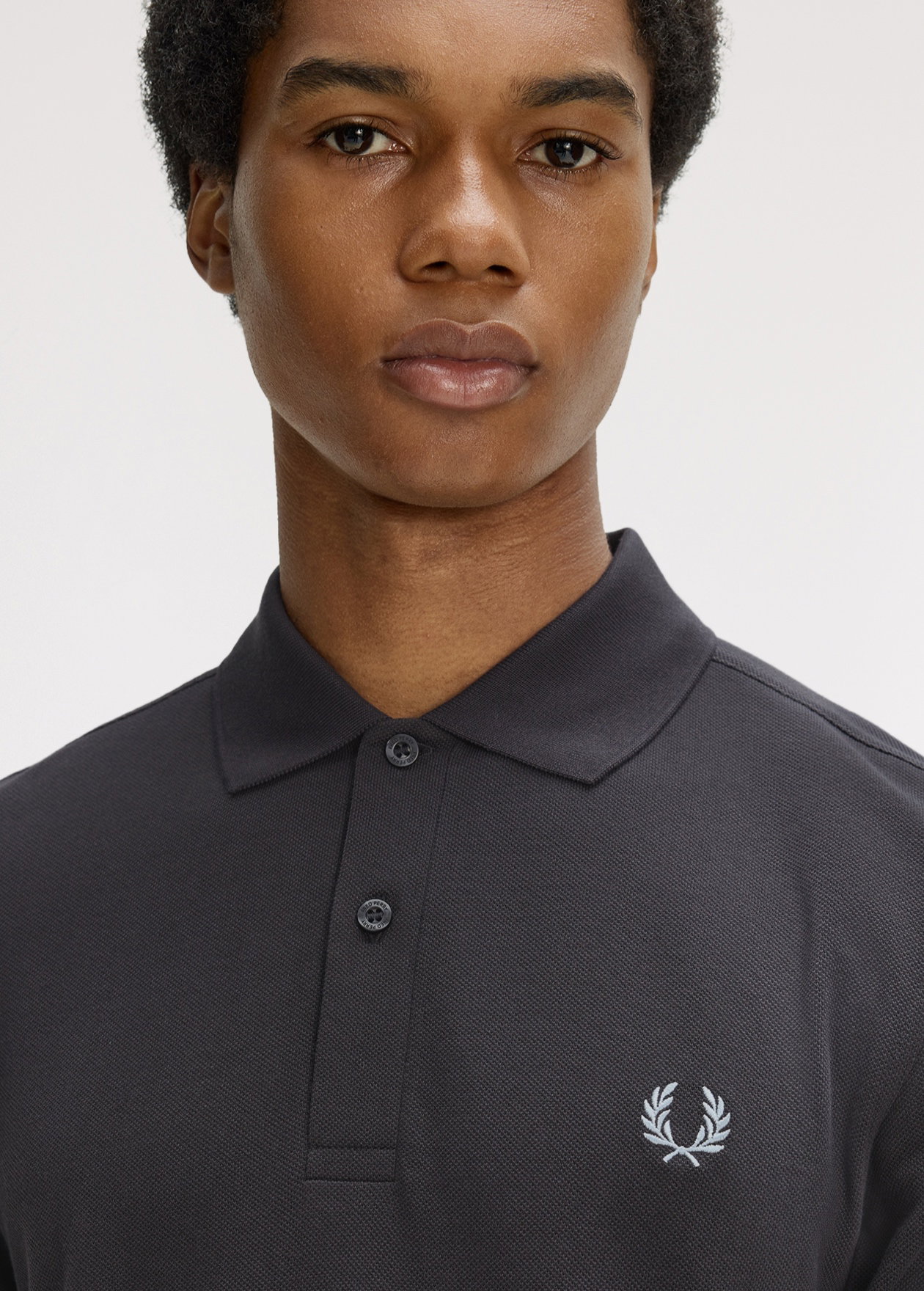 New Releases Men: male model wears Fred Perry Shirt in Anchor Grey