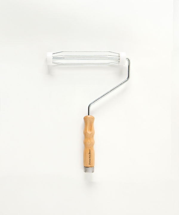 A Farrow & Ball paint roller frame with a wooden handle and wire cage.