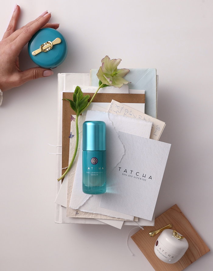 Tatcha products, the Longevity Memory Cream, the Longevity Serum, and the Silk Peony eye cream, laid on top of a stack of envelopes and papers.