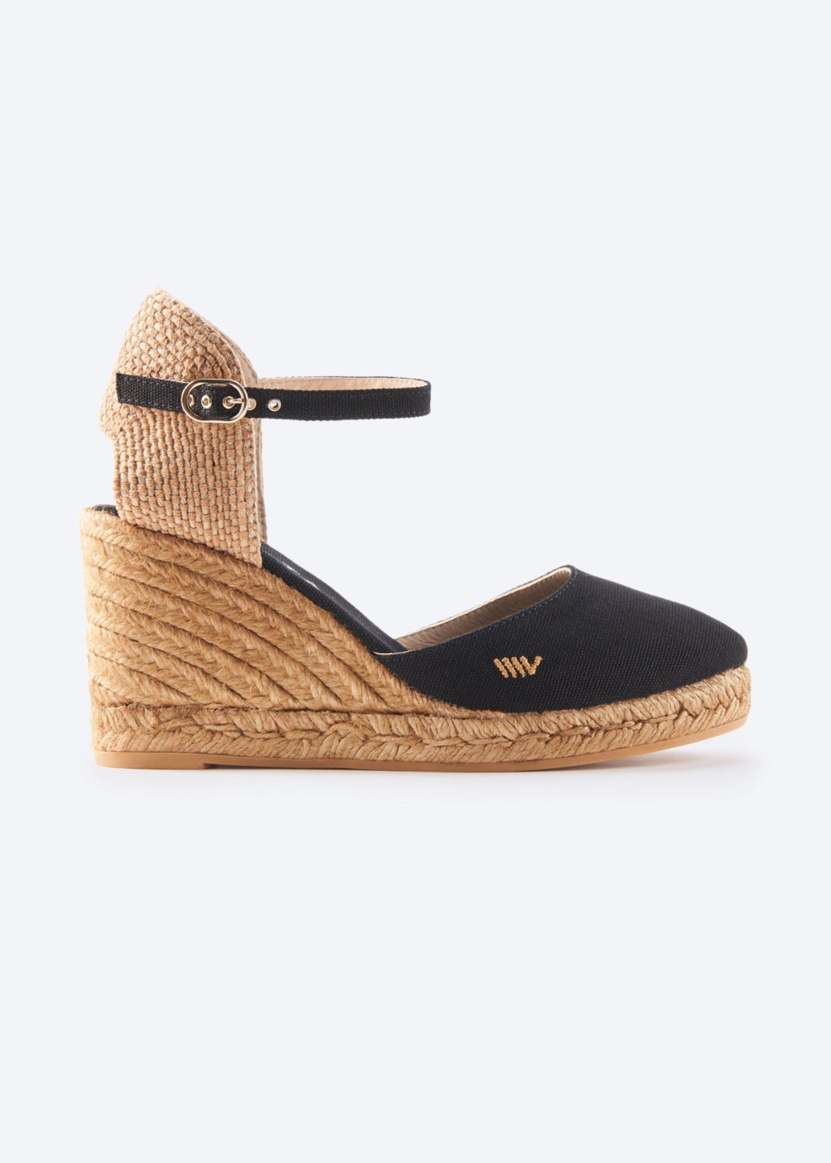 Black canvas espadrille wedge with ankle strap and braided jute heel on a clean background.