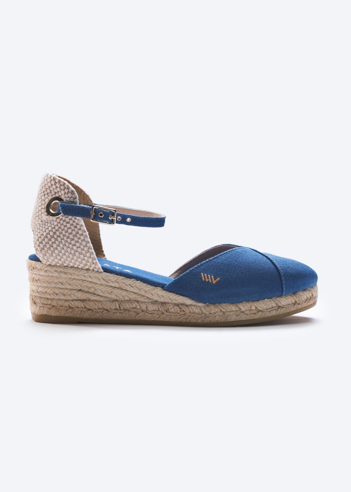 Blue canvas espadrille low wedge with ankle strap and braided jute heel on a clean background.