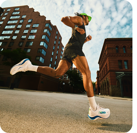Images of: a person mid run on a street, a person wearing the Airolite Tank 2.0, a person wearing the Glide Shorts, the Skyward X2 road running shoe in  Grout / Cobalt.