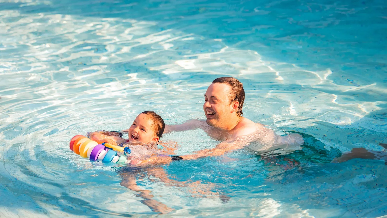 Father and daughter swimming in the Blue Lagoon