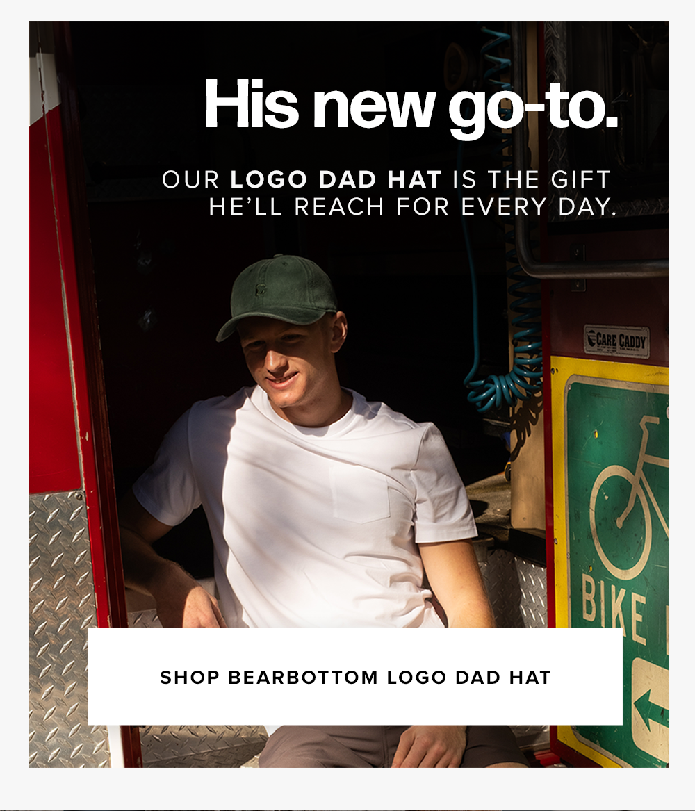 A man wearing a green baseball cap and a white t-shirt sits in the open doorway of a vehicle, partially shaded. Text reads: 'His new go-to. Our Logo Dad Hat... Shop Bearbottom Logo Dad Hat'