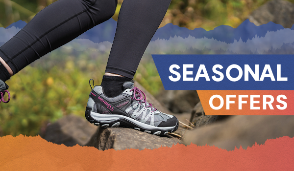 SEASONAL OFFERS. A woman walks on the trail wearing Merrell Women's Accentor Sport 3 GORE-TEX Hiking Shoes.