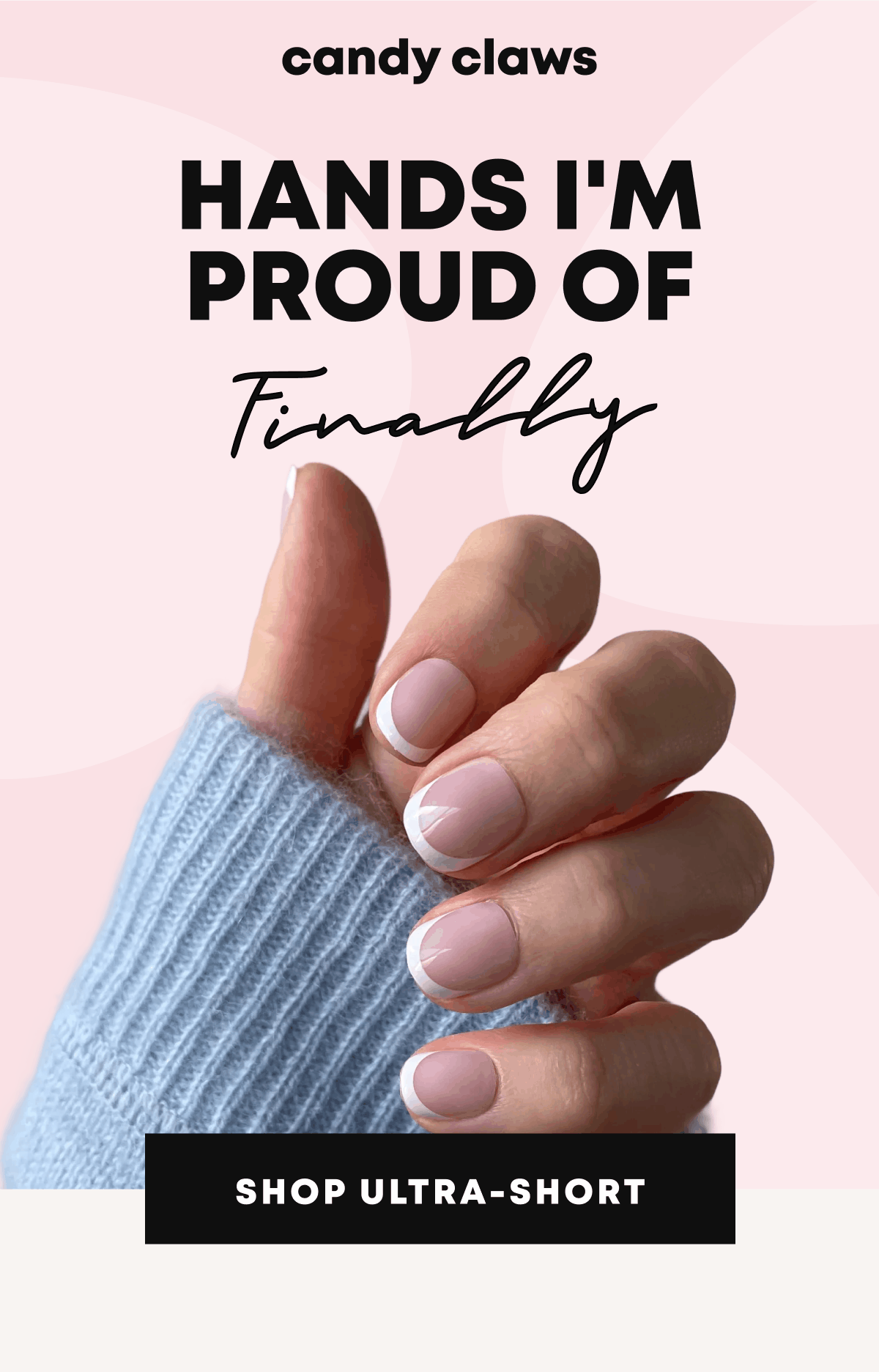 Hand with ultra-short pink nails wearing blue knit sweater on pink background