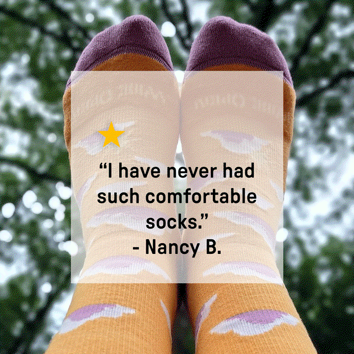 "I have never had such comfortable socks" overlay review over feet wearing orange socks with pink clouds.