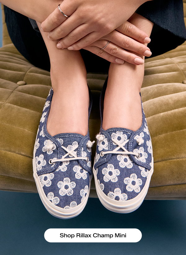 A close-up, top-down view of the Rillax Champ Mini Chambray Floral Embroidery Slip-On in light blue shown on foot. Shop Rillax Champ Mini.