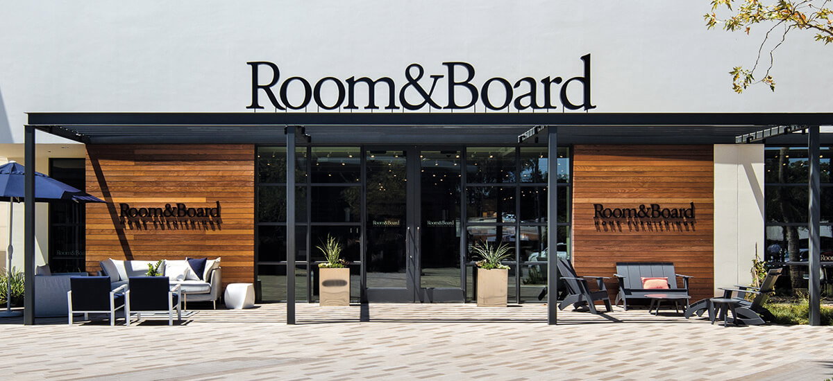 Front patio of the San Diego showroom with Room & Board signs above and to the sides of the doors.