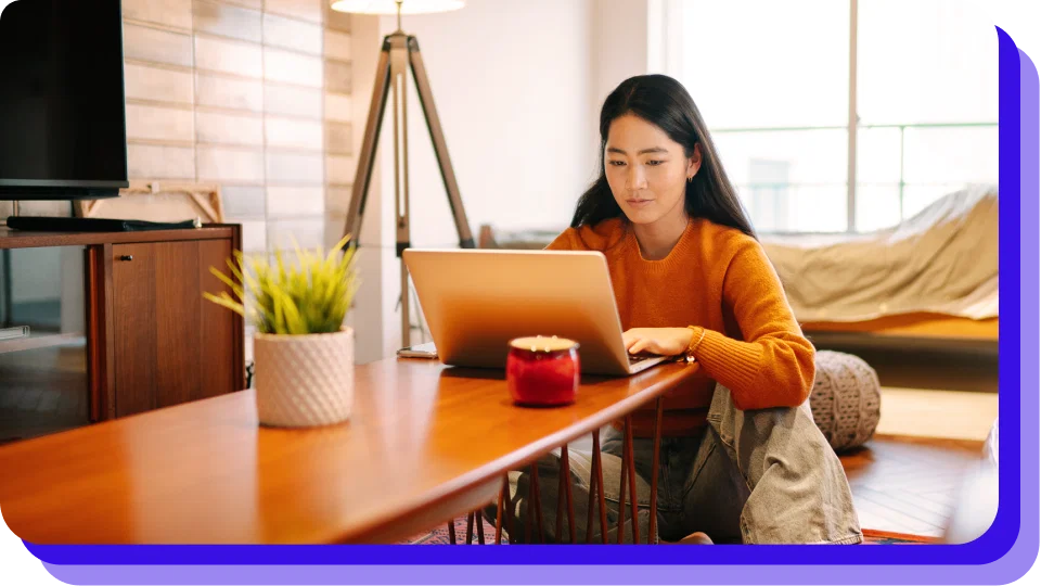 Person sitting in a desk while working on a laptop