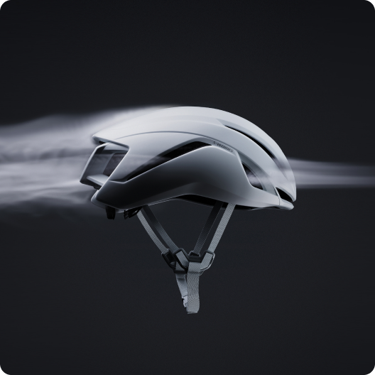 Aerodynamic white cycling helmet with adjustable chin straps shown with airflow trails on dark background