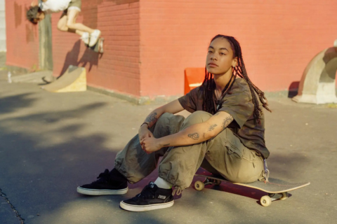 Vrouw zit op skateboard