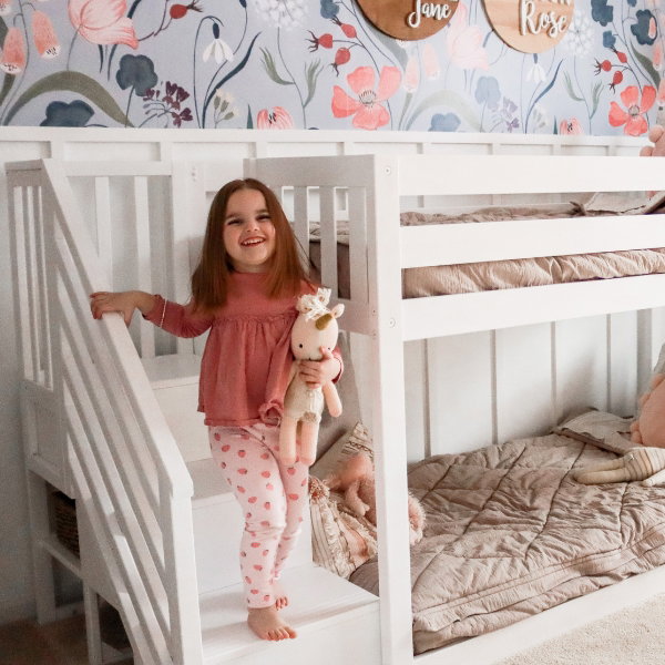 Girl's room with wallpaper and white bunk bed