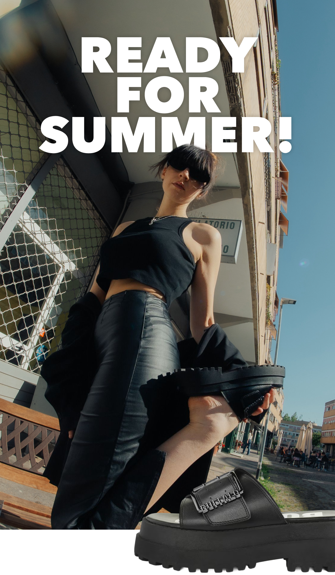 Promotional image showing a person in an urban street setting wearing a black outfit and platform slides, with the text ‘Ready for Summer!’