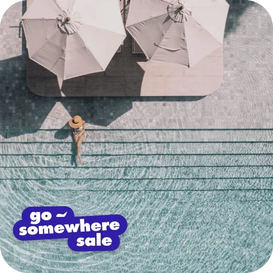 Person sitting on the steps at a pool