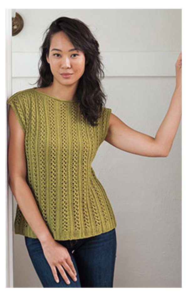 A model is wearing a green knit top. >>