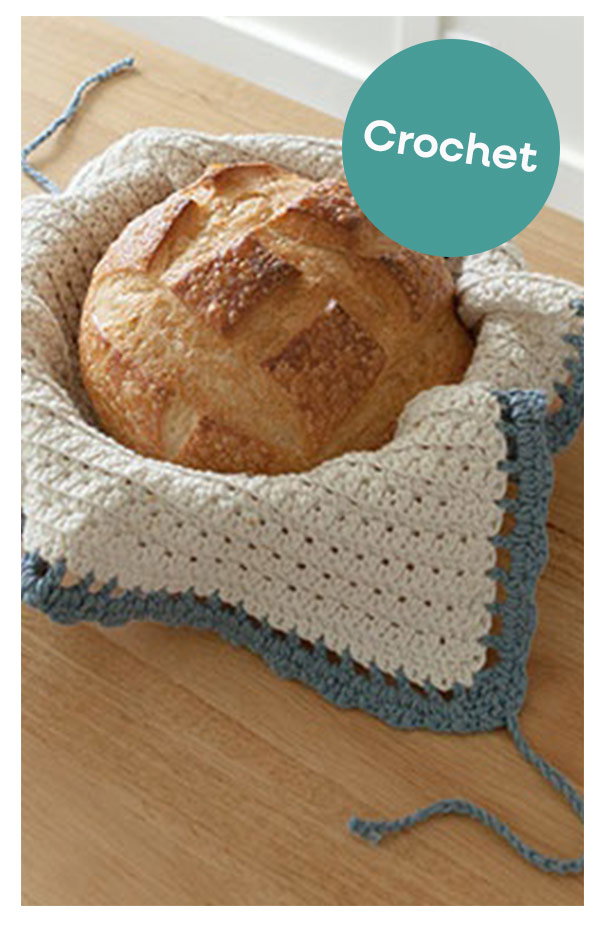 Image: A loaf of bread is nestled in a crocheted bread warmer. Text: Crochet >>