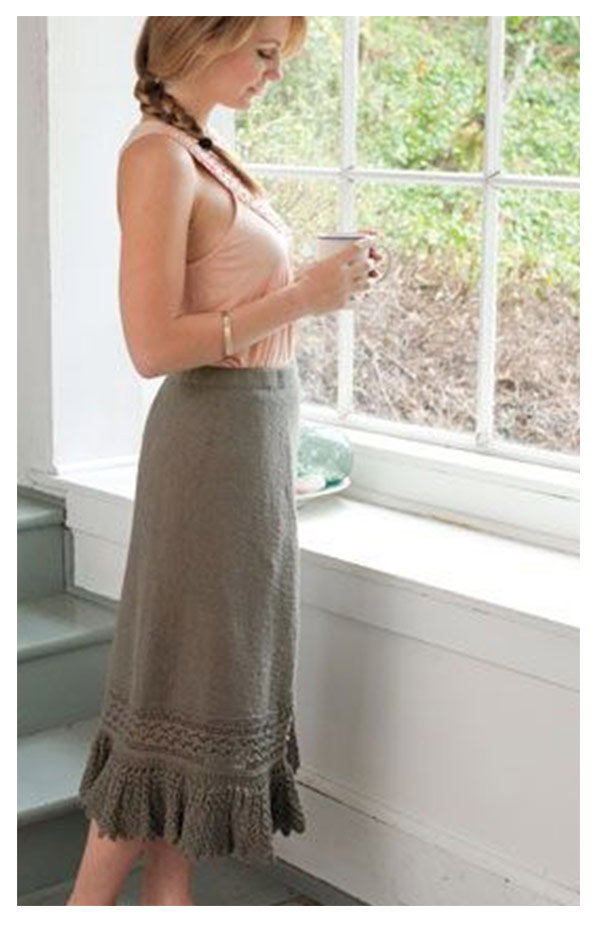 A model is wearing a knit ruffle hemmed skirt. >>