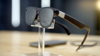 Android XR glasses on a clear plastic stand