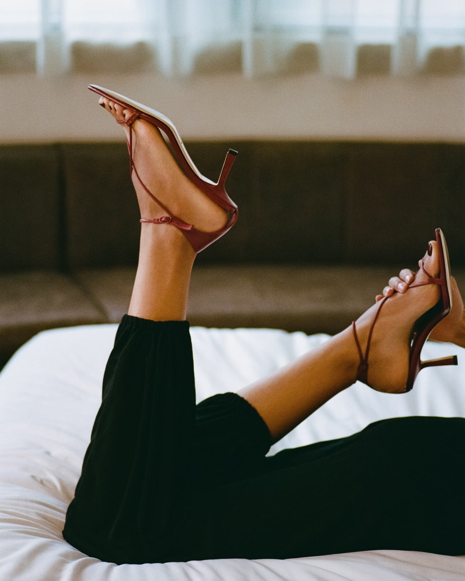 A woman wearing red leather high heels
