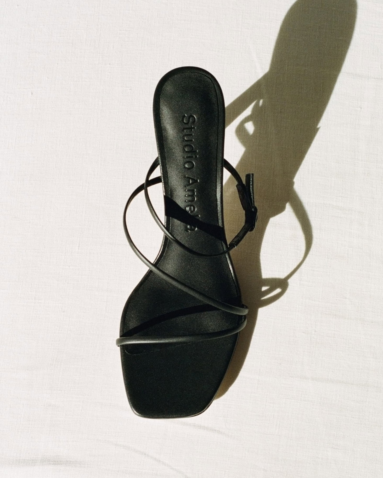 A black leather sandal with cross straps