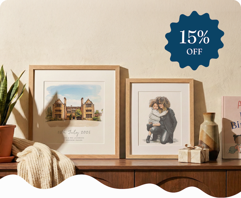 Two framed watercolour illustrations on a sideboard — a personalised wedding venue sketch and a portrait of a mother and child