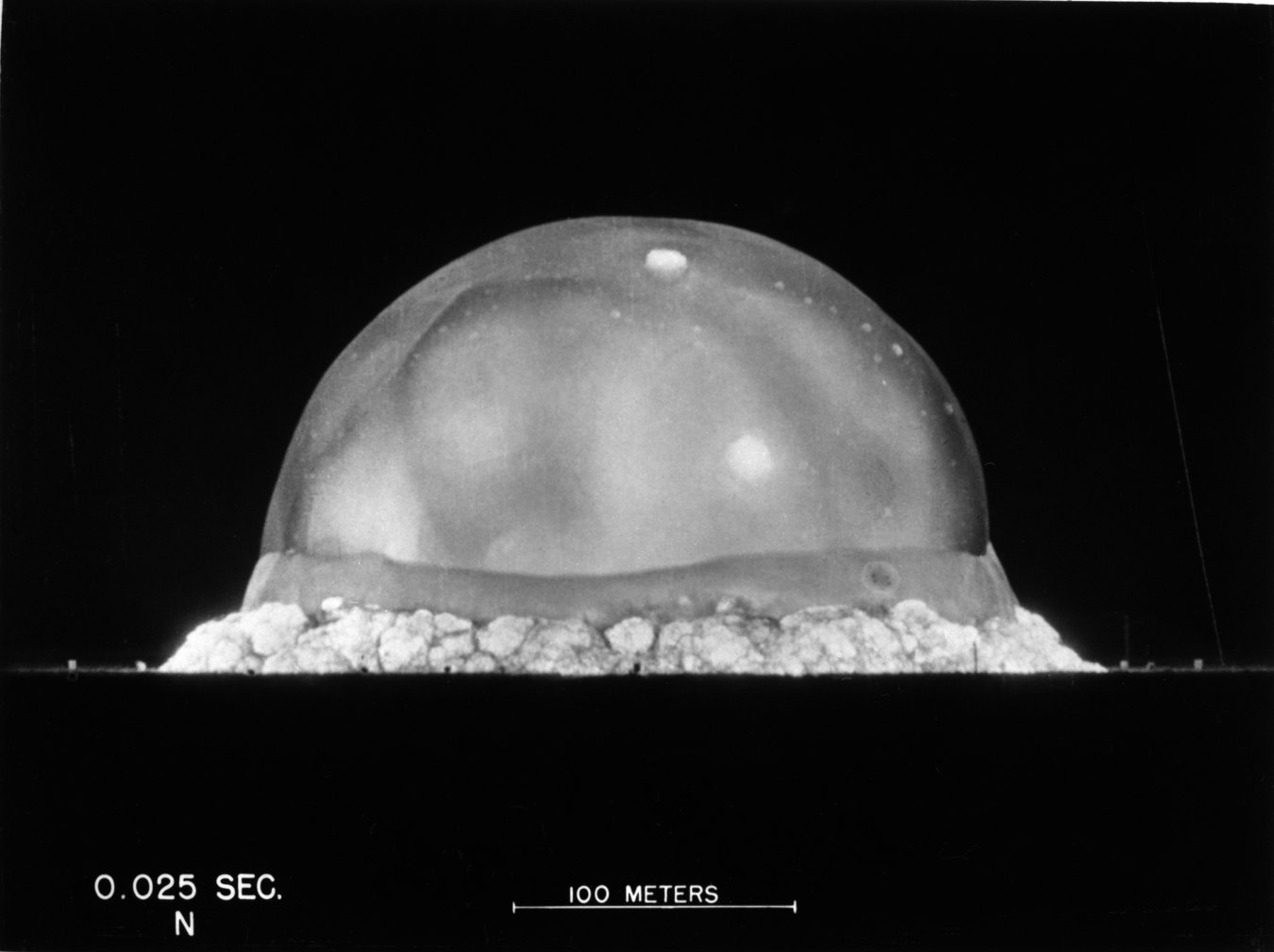 The early moments of a nuclear blast in the New Mexico desert in 1945. The translucent orb of heat and light is surrounded by a dust “skirt” and a shockwave “belt”. Image links to the article.