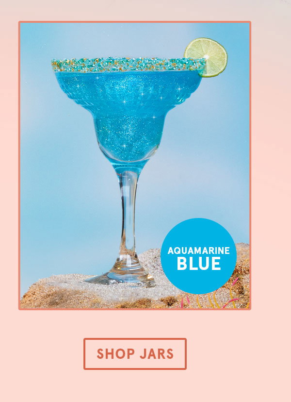 A clear margarita glass with Aquamarine Blue edible glitter drink